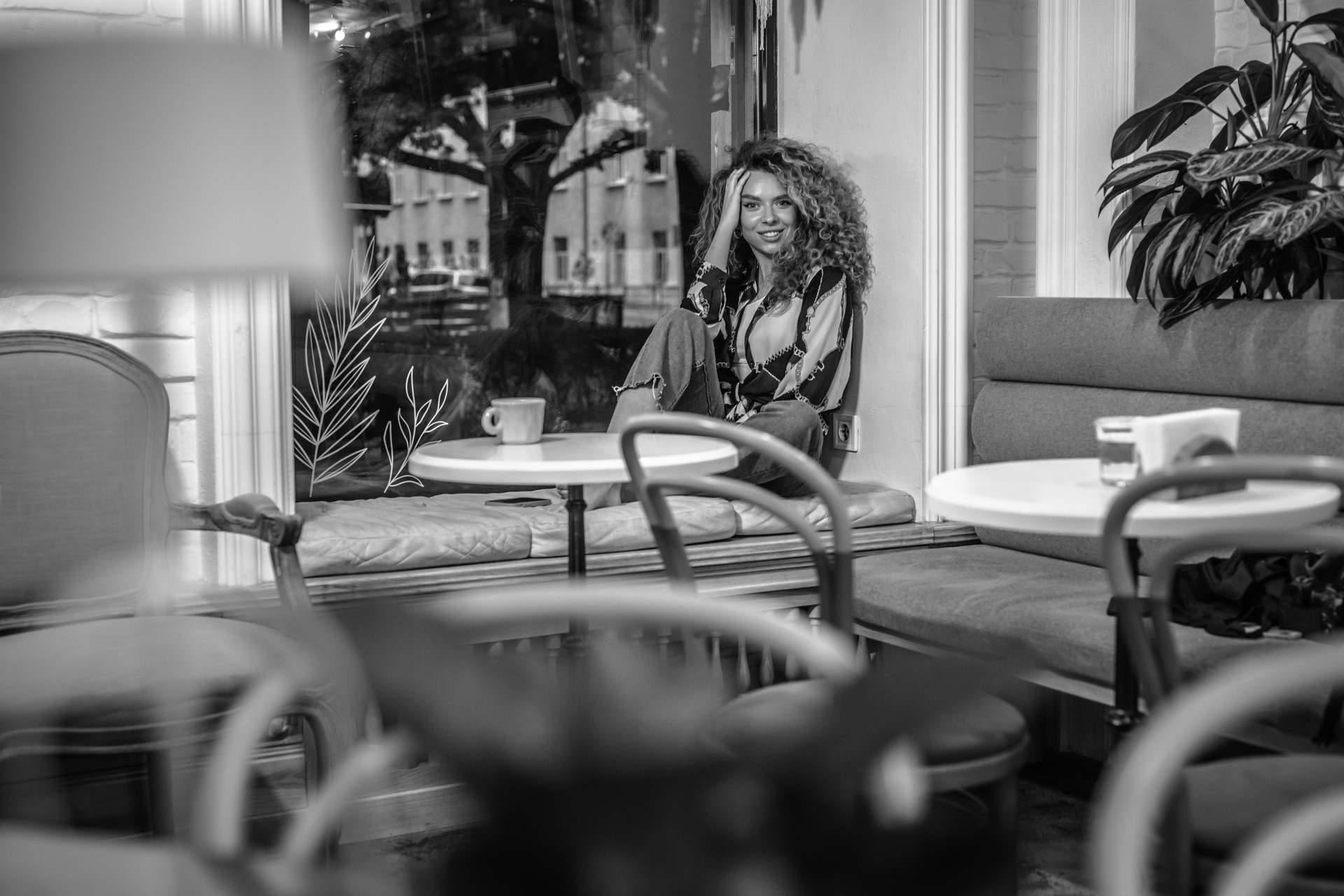 Pretty Young Woman With Curly Hair Relaxing In Cafe