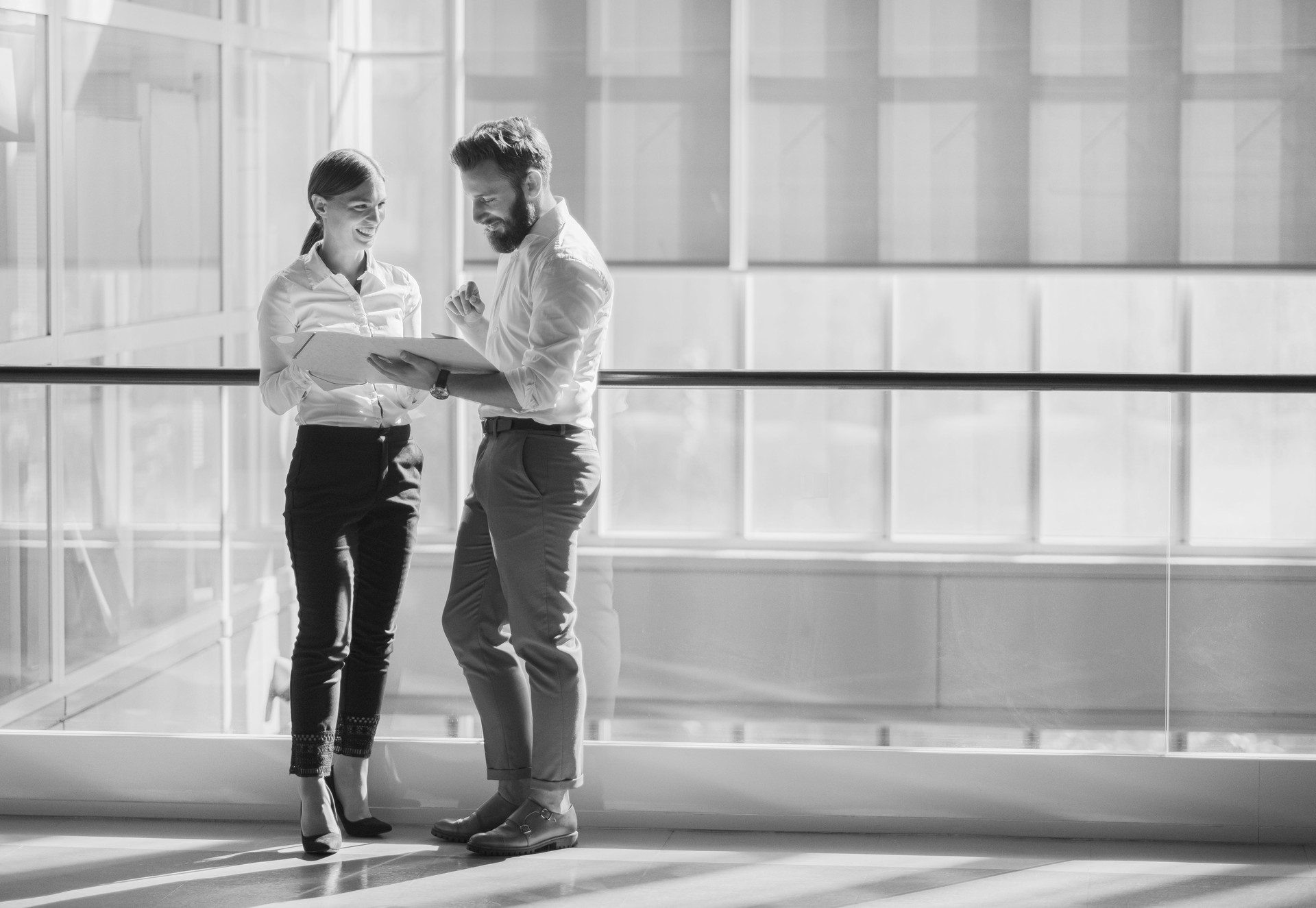 Business colleague talking in the office building lobby